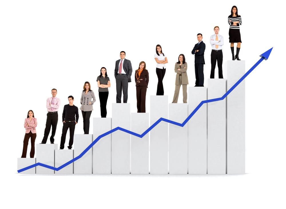 group of business people with a chart representing growth and success - isolated over a white background